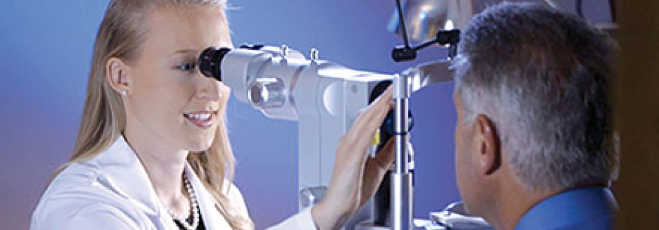 Dr. Christy Benson examines a man's eye during eye exam