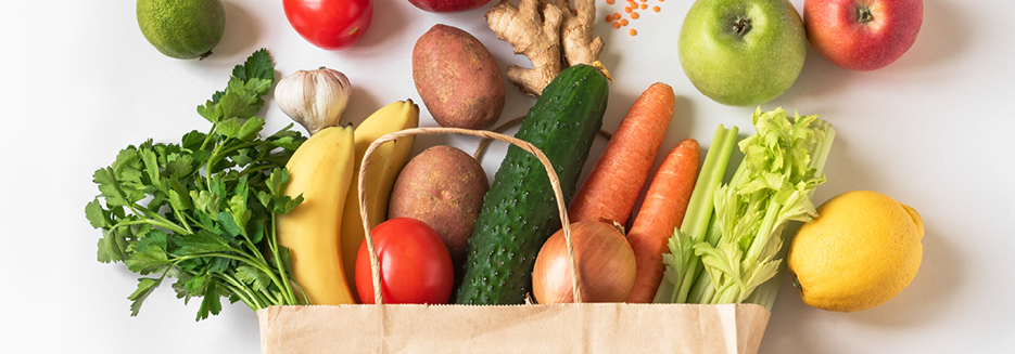 Healthy fruits and vegetables in brown paper bag